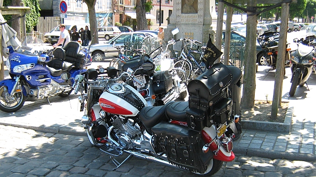 motorbikes parked on the footpath in the sunshine of honfleur
